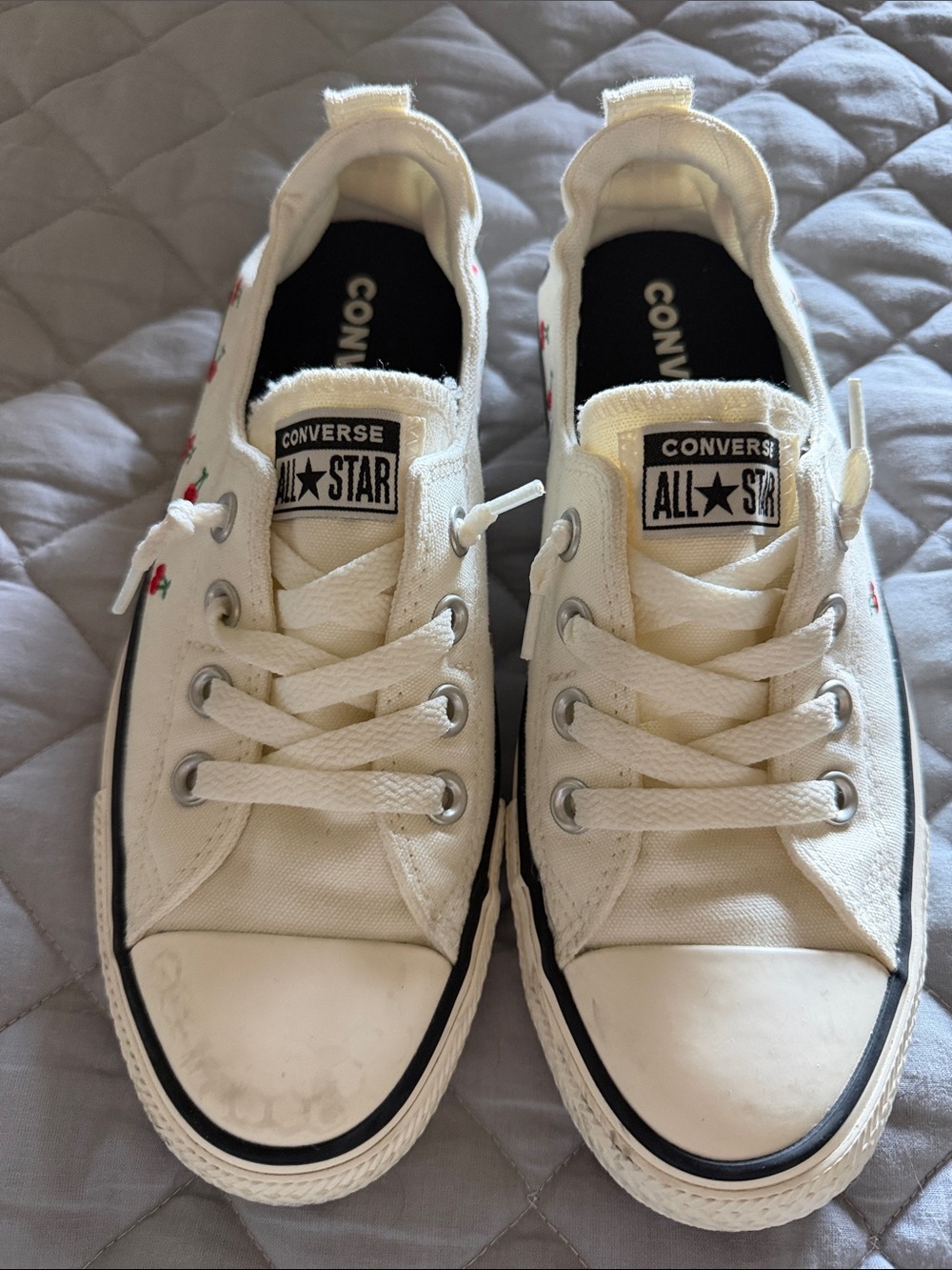 Converse White Low-Top Sneakers with Black Trim and Red Cherry Accents